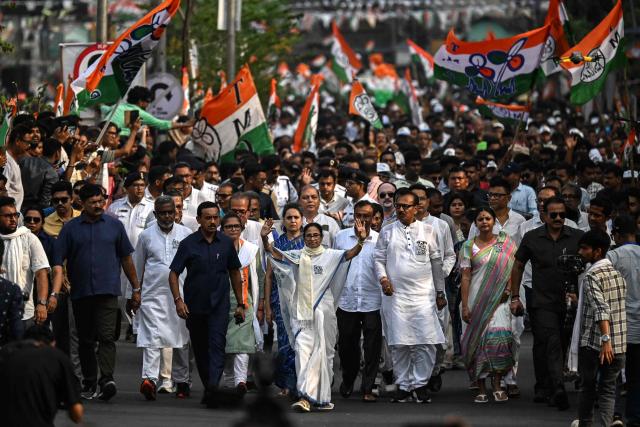 Chief Minister of West Bengal and Chairperson of All India Trinamool Congress, Mamata Banerjee (C), greets her supporters during a rally ahead of the second phase of the West Bengal Assembly Elections in Kolkata on April 27, 2026. (Photo by Dibyangshu SARKAR / AFP)