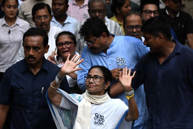 Chief Minister of West Bengal and Chairperson of All India Trinamool Congress, Mamata Banerjee (C), greets her supporters during a rally ahead of the second phase of the West Bengal Assembly Elections in Kolkata on April 27, 2026. (Photo by Dibyangshu SARKAR / AFP)