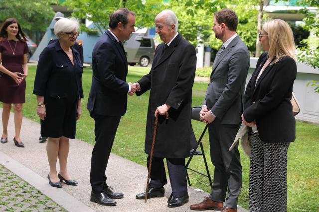 France's Prime Minister Sebastien Lecornu (3L) shakes hands with French former Prime Minister Edouard Balladur (C) next to France's Defence Minister Catherine Vautrin (2L) and High Commissioner for Strategy and Planning Clement Beaune (2R) during a military parade to mark the naming of the Ministry of the Armed Forces’ main auditorium after Pierre Messmer, at The Invalides in Paris on April 27, 2026. (Photo by Thomas SAMSON / AFP)
