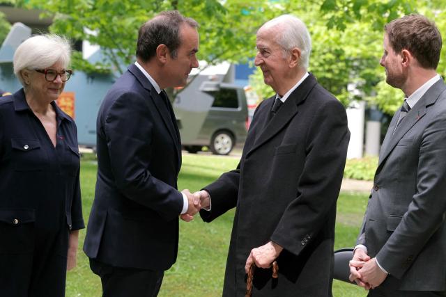 France's Prime Minister Sebastien Lecornu (2L) shakes hands with French former Prime Minister Edouard Balladur (2R) next to France's Defence Minister Catherine Vautrin (L) and High Commissioner for Strategy and Planning Clement Beaune (R) during a military parade to mark the naming of the Ministry of the Armed Forces’ main auditorium after Pierre Messmer, at The Invalides in Paris on April 27, 2026. (Photo by Thomas SAMSON / AFP)