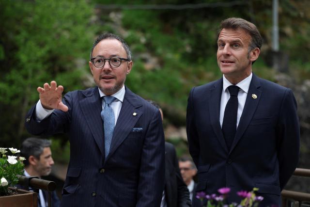 France's President and Co-Prince of Andorra Emmanuel Macron (R) is welcomed by Prime Minister of Andorra Xavier Espot Zamora at the start of a two-day official visit covering institutional talks on housing, abortion decriminalisation and Andorra's EU association agreement in Andorra, on April 27, 2026. (Photo by Valentine CHAPUIS / POOL / AFP)