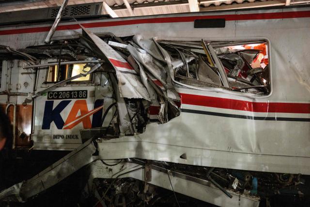 This photograph shows the site where a passenger train locomotive pierced through the rear carriage of a commuter train at Bekasi Timur Station in Bekasi, West Java, on April 28, 2026. Two trains collided outside the Indonesian capital Jakarta late on April 27, 2026, the state-owned rail company KAI said, killing at least two people and prompting a mass evacuation effort. (Photo by Yasuyoshi Chiba / AFP)