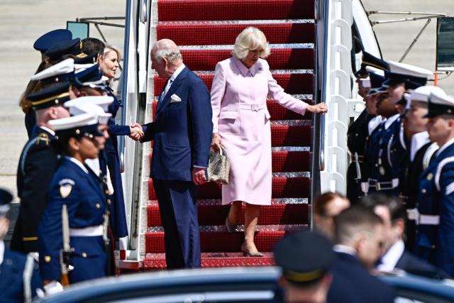 Britain's King Charles III and Britain's Queen Camilla are greeted by US Chief of Protocol Monica Crowley upon arrival at Joint Base Andrews, Maryland, on April 27, 2026. King Charles III arrives in Washington Monday for a high-stakes state visit aimed at salvaging Britain's frayed ties with Donald Trump, amid extra-tight security following an attack on a gala dinner attended by the US president. Tensions over the Iran war have rocked the so-called "special relationship" ahead of a trip that was meant to mark the United States' 250th anniversary of independence from the British monarch's ancestors. (Photo by Kent NISHIMURA / AFP)