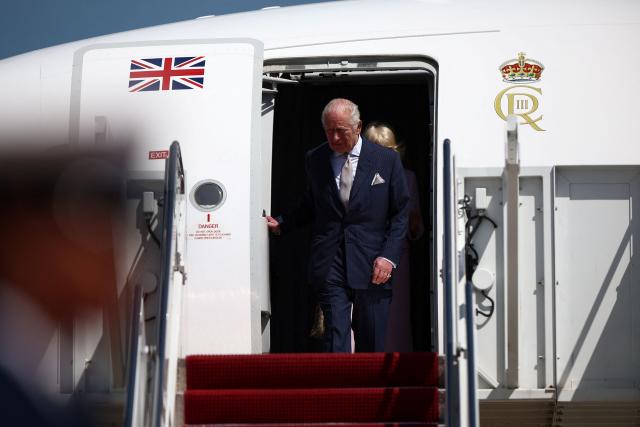 Britain's King Charles III and Queen Camilla arrive at Joint Base Andrews, Maryland, on April 27, 2026. King Charles III arrives in Washington Monday for a high-stakes state visit aimed at salvaging Britain's frayed ties with Donald Trump, amid extra-tight security following an attack on a gala dinner attended by the US president. Tensions over the Iran war have rocked the so-called "special relationship" ahead of a trip that was meant to mark the United States' 250th anniversary of independence from the British monarch's ancestors. (Photo by HENRY NICHOLLS / POOL / AFP)
