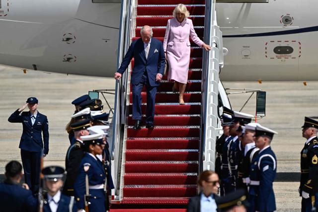 Britain's King Charles III and Britain's Queen Camilla step off their plane upon arrival at Joint Base Andrews, Maryland, on April 27, 2026. King Charles III arrives in Washington Monday for a high-stakes state visit aimed at salvaging Britain's frayed ties with Donald Trump, amid extra-tight security following an attack on a gala dinner attended by the US president. Tensions over the Iran war have rocked the so-called "special relationship" ahead of a trip that was meant to mark the United States' 250th anniversary of independence from the British monarch's ancestors. (Photo by Kent NISHIMURA / AFP)