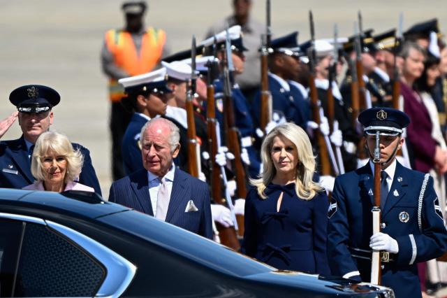 Britain's King Charles III and Britain's Queen Camilla walk toward an awaiting vehicle flanked by US Protocol Chief Monica Crowley (R) after arriving at Joint Base Andrews, Maryland, on April 27, 2026. King Charles III arrives in Washington Monday for a high-stakes state visit aimed at salvaging Britain's frayed ties with Donald Trump, amid extra-tight security following an attack on a gala dinner attended by the US president. Tensions over the Iran war have rocked the so-called "special relationship" ahead of a trip that was meant to mark the United States' 250th anniversary of independence from the British monarch's ancestors. (Photo by Kent NISHIMURA / AFP)