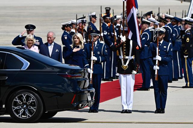 Britain's King Charles III and Britain's Queen Camilla walk toward an awaiting vehicle flanked by US Protocol Chief Monica Crowley after arriving at Joint Base Andrews, Maryland, on April 27, 2026. King Charles III arrives in Washington Monday for a high-stakes state visit aimed at salvaging Britain's frayed ties with Donald Trump, amid extra-tight security following an attack on a gala dinner attended by the US president. Tensions over the Iran war have rocked the so-called "special relationship" ahead of a trip that was meant to mark the United States' 250th anniversary of independence from the British monarch's ancestors. (Photo by Kent NISHIMURA / AFP)