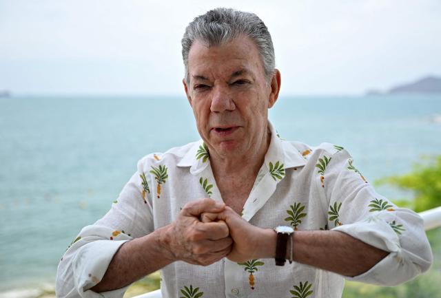 Colombia's former president (2010-2018) Juan Manuel Santos gestures as he speaks during an interview with AFP in the sidelines of the First Conference Transitioning away from Fossil Fuels at Port Beach in Santa Marta, on April 27, 2026. (Photo by Raul ARBOLEDA / AFP)