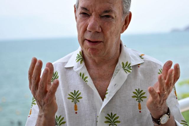 Colombia's former president (2010-2018) Juan Manuel Santos gestures as he speaks during an interview with AFP in the sidelines of the First Conference Transitioning away from Fossil Fuels at Port Beach in Santa Marta, on April 27, 2026. (Photo by Raul ARBOLEDA / AFP)