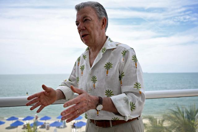Colombia's former president (2010-2018) Juan Manuel Santos gestures as he speaks during an interview with AFP in the sidelines of the First Conference Transitioning away from Fossil Fuels at Port Beach in Santa Marta, on April 27, 2026. (Photo by Raul ARBOLEDA / AFP)
