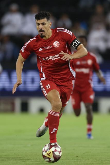 Shamal's forward #11 Baghdad Bounedjah runs with the ball during the Qatar Stars League match between Al-Sadd and Al-Shamal at Jassim Bin Hamad Stadium in Doha on April 27, 2026. (Photo by Karim JAAFAR / AFP)