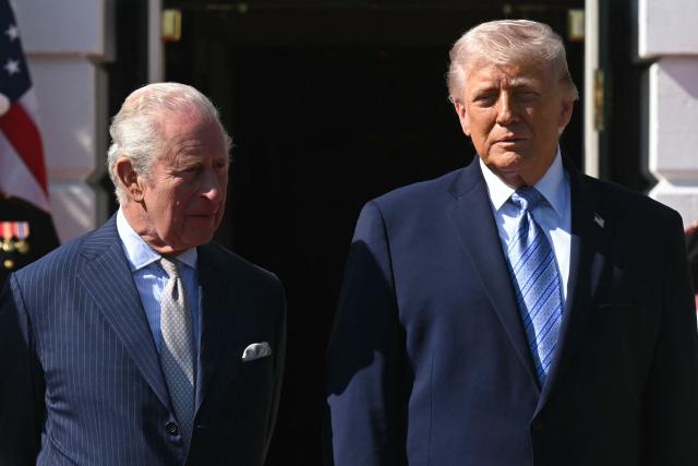 US President Donald Trump (R) greets Britain's King Charles III upon arrival at the South Portico of the White House in Washington, DC, on April 27, 2026. (Photo by SAUL LOEB / AFP)