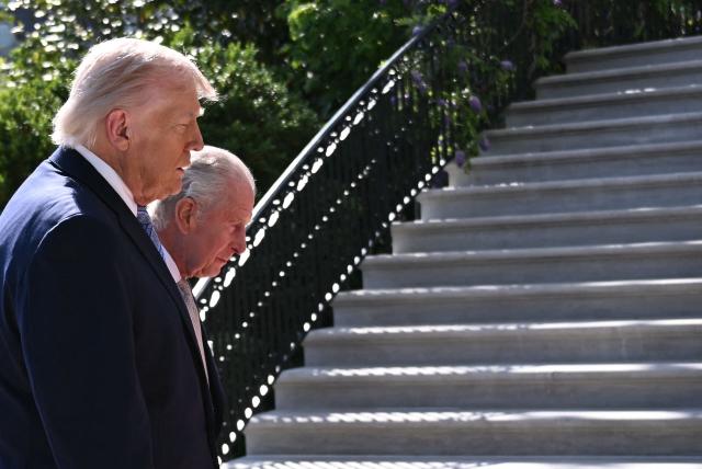 US President Donald Trump walks with Britain's King Charles III upon arrival at the South Portico of the White House in Washington, DC, on April 27, 2026. King Charles III arrives in Washington Monday for a high-stakes state visit aimed at salvaging Britain's frayed ties with Donald Trump, amid extra-tight security following an attack on a gala dinner attended by the US president. Tensions over the Iran war have rocked the so-called "special relationship" ahead of a trip that was meant to mark the United States' 250th anniversary of independence from the British monarch's ancestors. (Photo by Brendan SMIALOWSKI / AFP)