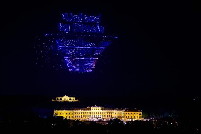 The 'United by Music' logo is formed using 3000 drones over Schonbrunn Palace during a drone show to mark the opening of Eurovision 2026 Song Contest in Vienna on April 27, 2026. (Photo by MAX SLOVENCIK / APA / AFP) / Austria OUT