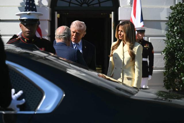 US President Donald Trump (C) and First Lady Melania Trump (R) greet Britain's King Charles III upon his arrival at the South Portico of the White House in Washington, DC, on April 27, 2026. (Photo by SAUL LOEB / AFP)