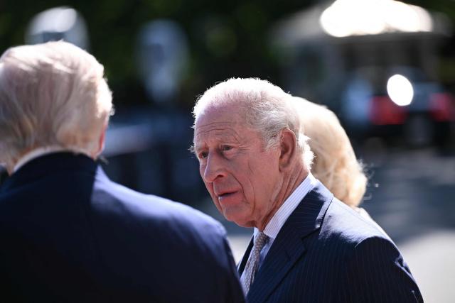 Britain's King Charles III listens to US President Donald Trump during his welcoming ceremony at the South Portico of the White House in Washington, DC, on April 27, 2026. (Photo by Brendan SMIALOWSKI / AFP)
