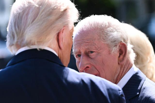 Britain's King Charles III listens to US President Donald Trump during his welcoming ceremony at the South Portico of the White House in Washington, DC, on April 27, 2026. (Photo by Brendan SMIALOWSKI / AFP)