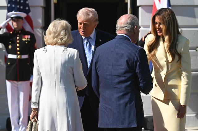 US President Donald Trump (C/R) and First Lady Melania Trump (R) greet Britain's King Charles III (C/R) and Britain's Queen Camilla upon arrival at the South Portico of the White House in Washington, DC, on April 27, 2026. (Photo by SAUL LOEB / AFP)