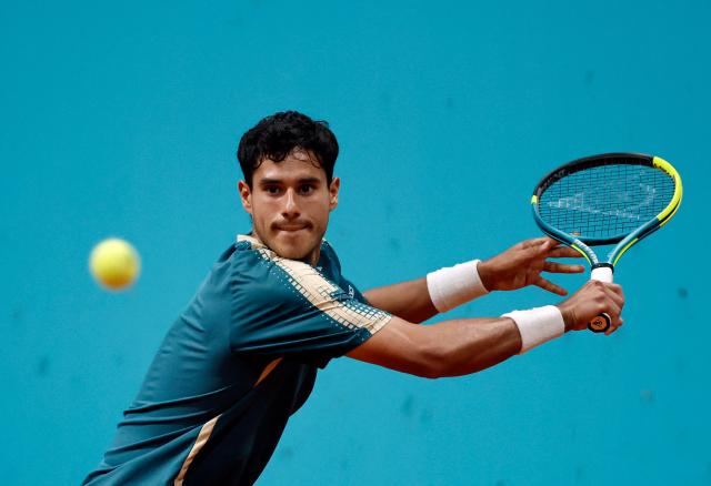 Paraguay's Adolfo Daniel Vallejo returns the ball to Italy's Flavio Cobolli during their 2026 ATP Tour Madrid Open tennis tournament third round singles match at the Caja Magica in Madrid, on April 27, 2026. (Photo by OSCAR DEL POZO / AFP)