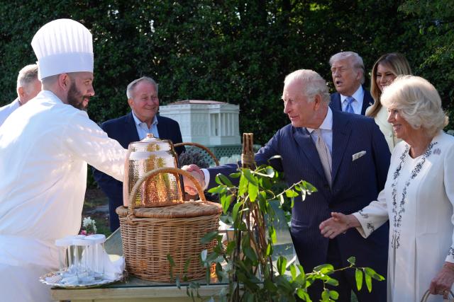 Britain's King Charles III and Queen Camilla talk with White House assistant pastry chef Carlo Figarella along with US President Donald Trump and First Lady Melania Trump as they look at a display at the White House garden on the South Lawn of the White House in Washington, DC, on April 27, 2026. (Photo by Alex Brandon / POOL / AFP)