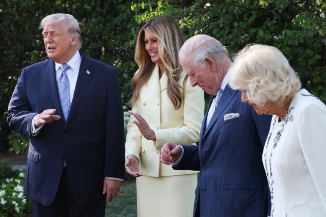 US President Donald Trump, First Lady Melania Trump, Britain's King Charles III and Britain's Queen Camilla look at a display as they tour the White House beehive on the South Lawn of the White House in Washington, DC, on April 27, 2026. (Photo by Suzanne Plunkett / POOL / AFP)