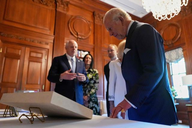 Britain's King Charles III (R) and Britain's Queen Camilla look over items to be placed in a time capsule in honor of the United States’ 250th anniversary in the Ambassador's Library room of the British Embassy in Washington, DC, on April 27, 2026. (Photo by Julia Demaree Nikhinson / POOL / AFP)