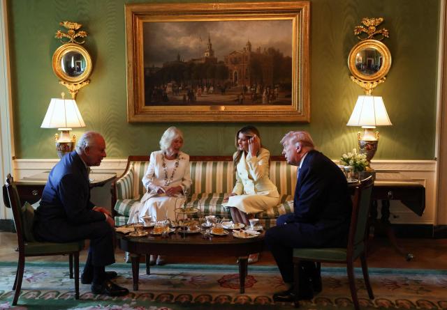US President Donald Trump and First Lady Melania Trump host Britain's King Charles III and Britain's Queen Camilla for tea in the Green Room of the White House in Washington, DC, on April 27, 2026. (Photo by Suzanne Plunkett / POOL / AFP)