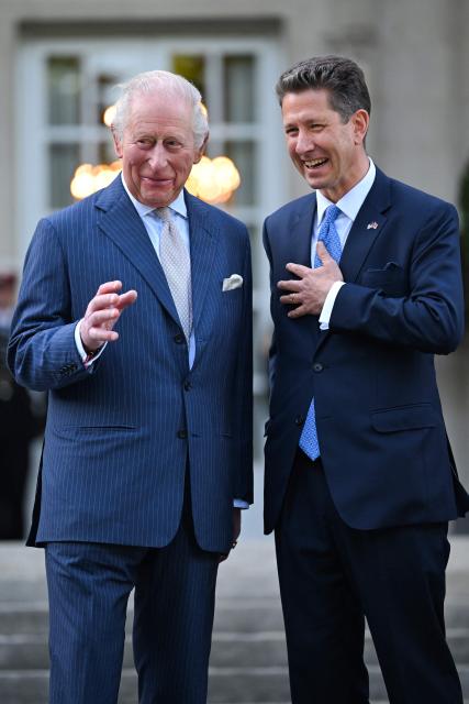 Britain's King Charles III laughs with British Ambassador to the US Christian Turner as they attend a garden party at the British Ambassador's Residence in Washington, DC, on April 27, 2026. (Photo by Samir HUSSEIN / POOL / AFP)