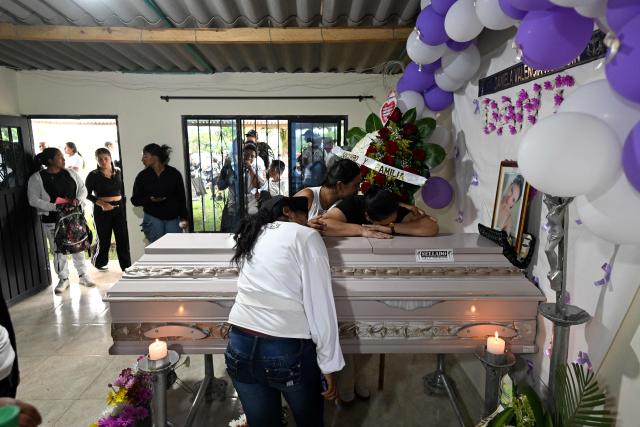 Relatives mourn by the coffin of Daniela Valencia Holguin, a fatal victim of a highway bombing in Cajibio, Cauca department, Colombia, on April 27, 2026. The death toll in a Colombian highway bombing blamed on cocaine-trafficking rebels rose to 21, the government said on April 27, after the worst attack on civilians in decades, coming ahead of key elections. (Photo by JOAQUIN SARMIENTO / AFP)