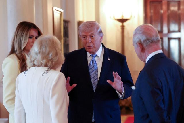 Britain's Queen Camilla (C/L), Britain's King Charles III (R) and US First Lady Melania Trump (L) listen to US President Donald Trump as they tour the White House in Washington, DC, on April 27, 2026. (Photo by Suzanne Plunkett / POOL / AFP)
