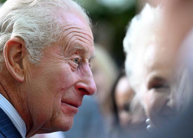 Britain's King Charles III greets attendees of a garden party at the British Ambassador's Residence in Washington, DC, on April 27, 2026. (Photo by Roberto Schmidt / POOL / AFP)