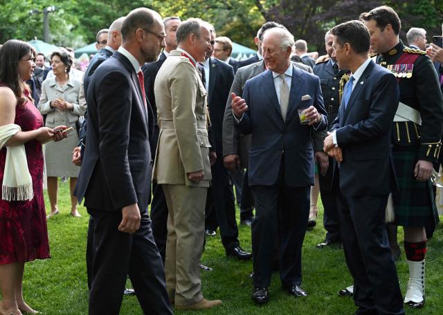Britain's King Charles III greets attendees of a garden party at the British Ambassador's Residence in Washington, DC, on April 27, 2026. (Photo by Roberto Schmidt / POOL / AFP)