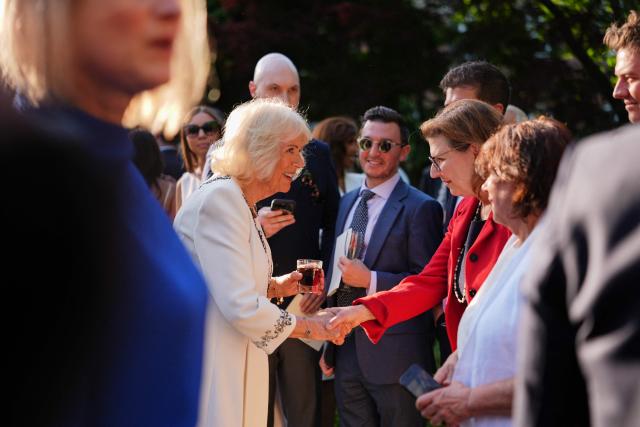 Britain's Queen Camilla greets attendees of a garden party at the British Ambassador's Residence in Washington, DC, on April 27, 2026. (Photo by Julia Demaree Nikhinson / POOL / AFP)