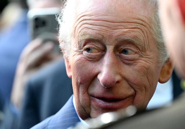 Britain's King Charles III greets attendees of a garden party at the British Ambassador's Residence in Washington, DC, on April 27, 2026. (Photo by Roberto Schmidt / POOL / AFP)