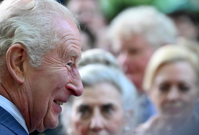 Britain's King Charles III greets attendees of a garden party at the British Ambassador's Residence in Washington, DC, on April 27, 2026. (Photo by Roberto Schmidt / POOL / AFP)