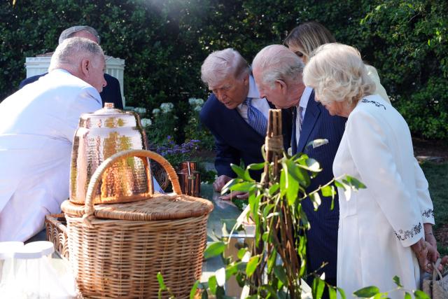 US President Donald Trump, First Lady Melania Trump, Britain's King Charles III and Britain's Queen Camilla tour the White House Beehive on the South Lawn of the White House in Washington, DC, on April 27, 2026. (Photo by Alex Brandon / POOL / AFP)