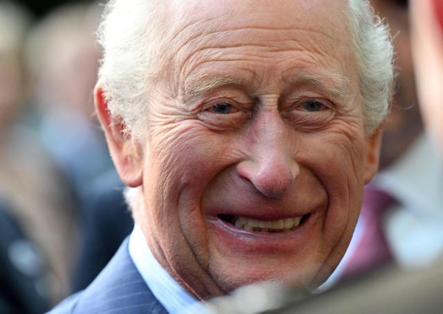 Britain's King Charles III smiles as he greets attendees of a garden party at the British Ambassador's Residence in Washington, DC, on April 27, 2026. (Photo by Roberto Schmidt / POOL / AFP)