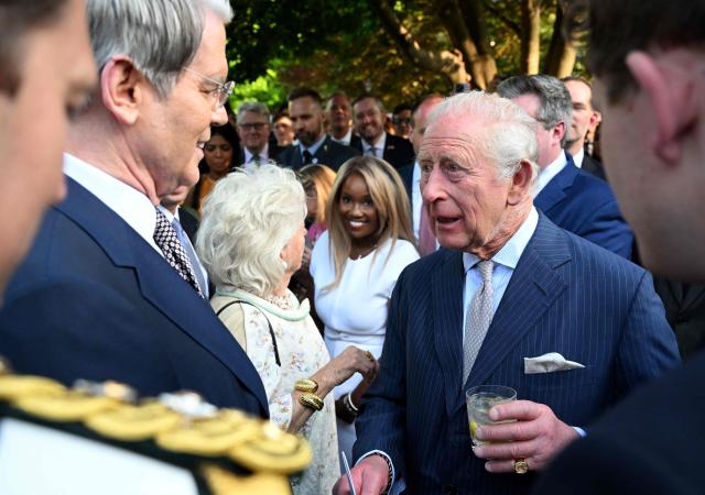 Britain's King Charles III talks with the US Treasury Secretary Scott Bessent during a garden party at the British Ambassador's Residence in Washington, DC, on April 27, 2026. (Photo by Roberto Schmidt / POOL / AFP)