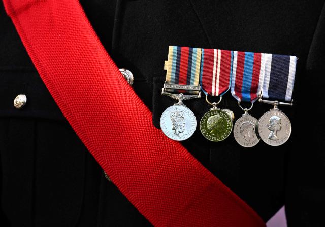 A Britain's Armed Forces service member wears his decorations during a garden party with Britain's King Charles III and Queen Camilla at the British Ambassador's Residence in Washington, DC, on April 27, 2026. (Photo by Roberto Schmidt / POOL / AFP)