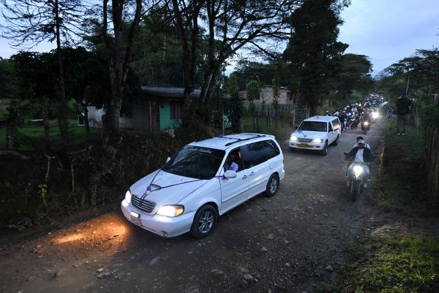 Vehicles drive during a funeral procession following a bomb attack in Cajibio, Cauca department, Colombia, on April 27, 2026. The death toll in a Colombian highway bombing blamed on cocaine-trafficking rebels rose to 21, the government said on April 27, after the worst attack on civilians in decades, coming ahead of key elections. (Photo by JOAQUIN SARMIENTO / AFP)
