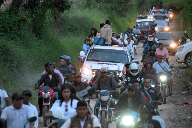 Vehicles drive during a funeral procession following a bomb attack in Cajibio, Cauca department, Colombia, on April 27, 2026. The death toll in a Colombian highway bombing blamed on cocaine-trafficking rebels rose to 21, the government said on April 27, after the worst attack on civilians in decades, coming ahead of key elections. (Photo by Joaquin SARMIENTO / AFP)