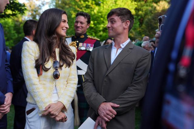 US journalist Kaitlan Collins (L) and retired diver and Olympic gold medallist Tom Daley attend a garden party with Britain's King Charles III and Queen Camilla at the British Ambassador's Residence in Washington, DC, on April 27, 2026. (Photo by Julia Demaree Nikhinson / POOL / AFP)