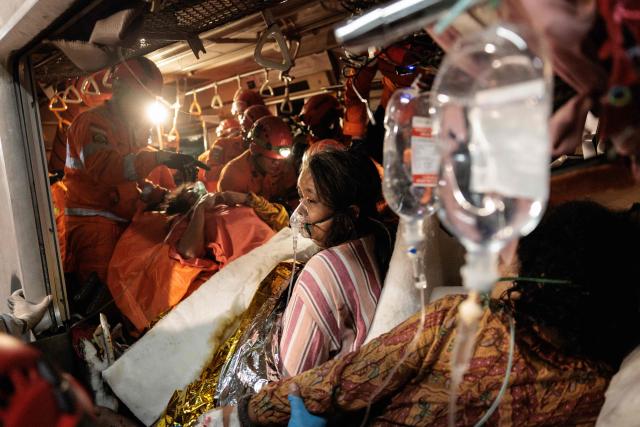 Rescuers work to save five survivors trapped inside a carriage after a passenger train locomotive pierced through the rear car of a commuter train at Bekasi Timur station in Bekasi, West Java on April 28, 2026. (Photo by Yasuyoshi Chiba / AFP)