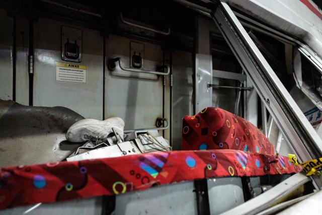A shoe is seen as rescuers work to save five survivors trapped inside a carriage after a passenger train locomotive pierced through the rear car of a commuter train at Bekasi Timur station in Bekasi, West Java on April 28, 2026. (Photo by Yasuyoshi Chiba / AFP)