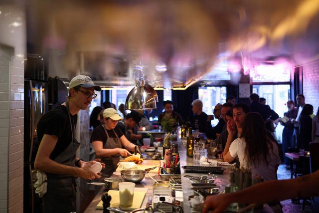 Customers eat dinner at the French restaurant Gigi’s in the Brooklyn borough of New York on April 26, 2026. Hugo Hivernat's restaurant was only open for a few days before he got dragged into New York City's cost of living row over a portion of half chicken priced at $40. For some on social media, the cost highlights how dining has become prohibitively expensive in the most populous US city. But Hivernat insists his business is barely making a profit. (Photo by CHARLY TRIBALLEAU / AFP)