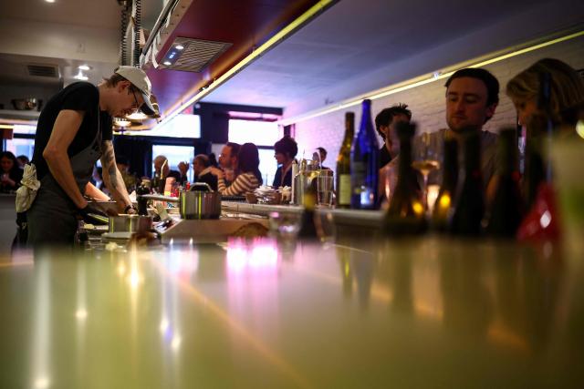 Customers eat dinner at the French restaurant Gigi’s in the Brooklyn borough of New York on April 26, 2026. Hugo Hivernat's restaurant was only open for a few days before he got dragged into New York City's cost of living row over a portion of half chicken priced at $40. For some on social media, the cost highlights how dining has become prohibitively expensive in the most populous US city. But Hivernat insists his business is barely making a profit. (Photo by CHARLY TRIBALLEAU / AFP)