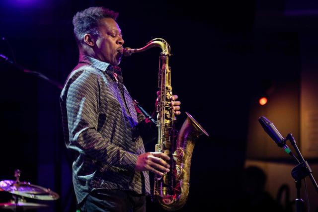 United States' saxophonist Ravi Coltrane performes on the stage of the Impart jazz club in Wroclaw during his concert with trumpeter and composer Terence Blanchard in honor of Miles Davis and John Coltrane as part of the Jazz nad Odra festival on April 26, 2026. Awash in purple and turquoise stage lights, a century after the birth of two of jazz's most formidable legacies -- Miles Davis and John Coltrane -- Ravi Coltrane and Terence Blanchard are refusing to recreate the past. (Photo by Wojtek RADWANSKI / AFP)