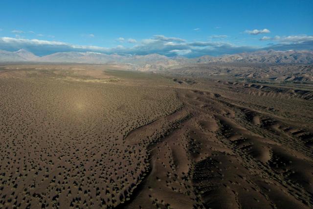 This aerial view shows the Andes Mountains in the background seen from Calingasta, San Juan province, Argentina, on April 20, 2026. (Photo by Luis ROBAYO / AFP)