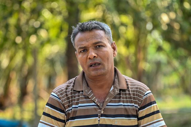 This photograph taken on April 2, 2026 shows Abdul Goni Gazi, a Sundarbans-based rescuer  known locally as 'Goni Tiger' renowned for assisting victims of tiger attacks, speaking during an interview with AFP at Shyamnagar in Bangladesh's Satkhira district. Tigers are so feared in Bangladesh's vast Sundarban mangroves that locals invoke spirits to protect against them. But experts say it is the big cats themselves that need defending. (Photo by Munir UZ ZAMAN / AFP) / TO GO WITH 'Bangladesh-Environment-Sundarbans-Tiger' FOCUS
