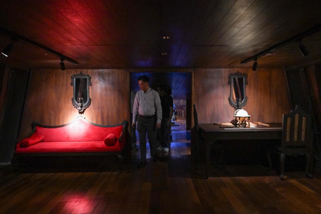 This photo taken on April 21, 2026 shows Museo del Galeon Executive Director Manuel Quezon leading a tour of the Galeon Espiritu Santo, a full-scale representation of a 17th century galleon, on display at the Museo del Galeon in Manila. A full-size replica of a Spanish galleon stares out into Manila Bay, the centrepiece of a museum that will transport visitors back to the 17th century, when conscripted Philippine mariners birthed the era of globalisation. (Photo by Jam STA ROSA / AFP) / To go with AFP story Philippines-history-culture-Spain-shipping, FOCUS by Cecil MORELLA